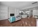 Open-concept living room with hardwood floors, built-in shelves, and seamless flow to the kitchen at 256 Rubrum Dr, Hillsborough, NC 27278