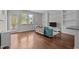 Sunlit living room with hardwood floors, built-in shelves, television and open doorway at 256 Rubrum Dr, Hillsborough, NC 27278