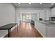 Open-concept living area with hardwood floors, lots of natural light, and a view into the kitchen at 256 Rubrum Dr, Hillsborough, NC 27278