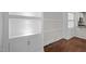 Living room featuring custom built-in shelving and hardwood floors at 256 Rubrum Dr, Hillsborough, NC 27278