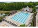 Community pool with surrounding lounge chairs and seating areas at 256 Rubrum Dr, Hillsborough, NC 27278