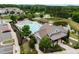 Aerial view of a community pool, clubhouse, cabana, and pond in a well-maintained neighborhood at 256 Rubrum Dr, Hillsborough, NC 27278
