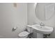 Neutral powder room showcasing a pedestal sink, commode, and a round mirror at 256 Rubrum Dr, Hillsborough, NC 27278