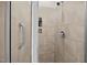Modern shower with beige tile, grab bar, and recessed shelf at 256 Rubrum Dr, Hillsborough, NC 27278