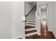 Staircase with hardwood treads and white risers, complemented by wooden handrail at 256 Rubrum Dr, Hillsborough, NC 27278