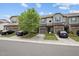 View of the townhomes and street, showcasing the home's curb appeal and landscaping at 256 Rubrum Dr, Hillsborough, NC 27278