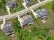 Aerial view showing the backyard and deck area of a house with nearby streets and sidewalks in a suburban neighborhood at 2711 Jordan Pointe Blvd, New Hill, NC 27562
