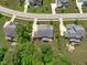 Aerial view displaying a backyard featuring a deck with seating and landscaping, backing to a wooded lot at 2711 Jordan Pointe Blvd, New Hill, NC 27562