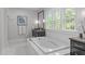 Elegant bathroom featuring a soaking tub, vanity, and a large window at 2711 Jordan Pointe Blvd, New Hill, NC 27562