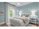 Light-filled bedroom with a comfy bed, side tables with lamps, and a window with light-filtering shades at 2711 Jordan Pointe Blvd, New Hill, NC 27562