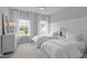 Bright bedroom featuring two beds, white walls, windows, and a ceiling fan at 2711 Jordan Pointe Blvd, New Hill, NC 27562