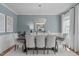 Dining room with a modern chandelier, seating for eight, and large windows that offer ample natural light at 2711 Jordan Pointe Blvd, New Hill, NC 27562