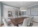 Elegant dining room with a large wooden table, seating for eight, and access to an office through a wide doorway at 2711 Jordan Pointe Blvd, New Hill, NC 27562