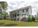 Home exterior featuring a screened porch, deck with white railings, and a well-maintained lawn at 2711 Jordan Pointe Blvd, New Hill, NC 27562