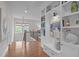 Hallway featuring hardwood floors, built-in bookshelves, and abundant natural light at 2711 Jordan Pointe Blvd, New Hill, NC 27562