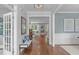 Inviting hallway with hardwood floors, a bench seat, and a view into the living room, creating a seamless flow at 2711 Jordan Pointe Blvd, New Hill, NC 27562