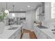 Bright kitchen with white cabinets, stainless appliances, large island and view of kitchen dining area at 2711 Jordan Pointe Blvd, New Hill, NC 27562