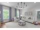 Cozy living room featuring stylish furniture, decor, and ample natural light from large windows at 2711 Jordan Pointe Blvd, New Hill, NC 27562