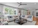 Bright living room area with lots of windows and seating with decorative pillows and tables at 2711 Jordan Pointe Blvd, New Hill, NC 27562