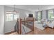 Open-concept living room with hardwood floors and large windows offering plenty of natural light at 2711 Jordan Pointe Blvd, New Hill, NC 27562