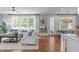 Bright living room with hardwood floors, large windows, a ceiling fan, and a comfortable seating area at 2711 Jordan Pointe Blvd, New Hill, NC 27562