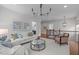 Upstairs living room featuring hardwood floors, modern lighting, and comfortable seating at 2711 Jordan Pointe Blvd, New Hill, NC 27562