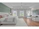 Bright and airy main bedroom featuring tray ceiling, a sitting area, and hardwood floors at 2711 Jordan Pointe Blvd, New Hill, NC 27562