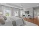 Main bedroom featuring a sitting area, tray ceiling, hardwood floors, and lots of natural light at 2711 Jordan Pointe Blvd, New Hill, NC 27562