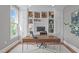 Office with custom built-in shelves, a modern desk, and a comfortable chair, ideal for a productive work environment at 2711 Jordan Pointe Blvd, New Hill, NC 27562