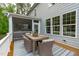 Outdoor dining area with a table and seating for six overlooks the backyard at 2711 Jordan Pointe Blvd, New Hill, NC 27562