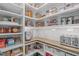 Well-organized walk-in pantry with lots of shelving, bins, and a corner countertop at 2711 Jordan Pointe Blvd, New Hill, NC 27562