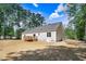 Back of house featuring deck and large backyard surrounded by trees at 295 Rudd Rd, Youngsville, NC 27596