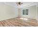 Spacious bedroom with ample natural light, wood-look floors, and crown molding at 295 Rudd Rd, Youngsville, NC 27596