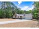 Charming single-Gathering home featuring an attached two-car garage, front porch, and long driveway at 295 Rudd Rd, Youngsville, NC 27596