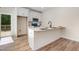 Modern kitchen featuring white cabinets, stainless steel appliances, and island with breakfast bar at 295 Rudd Rd, Youngsville, NC 27596