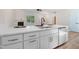 Bright kitchen with white cabinets, stainless steel appliances, and a central island with seating at 295 Rudd Rd, Youngsville, NC 27596