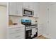 Modern kitchen with stainless steel appliances, white cabinets, and subway tile backsplash at 295 Rudd Rd, Youngsville, NC 27596