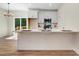 Bright kitchen with white cabinets, stainless steel appliances, and large island with bar seating at 295 Rudd Rd, Youngsville, NC 27596