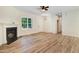 Bright and airy living space with wood floors, fireplace, and large window at 295 Rudd Rd, Youngsville, NC 27596