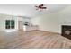 Bright and airy living space with wood floors, fireplace, and a sliding glass door to deck at 295 Rudd Rd, Youngsville, NC 27596