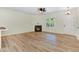 Bright and airy living space with wood floors, fireplace, and white trim at 295 Rudd Rd, Youngsville, NC 27596