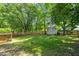 A fenced backyard with a small shed and plenty of space for outdoor activities at 3 Cobble Glen Ct, Durham, NC 27713