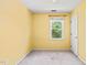 This bedroom features bright yellow walls and a window offering natural light at 3 Cobble Glen Ct, Durham, NC 27713