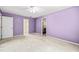 Bedroom with purple walls, carpet floors, and a view to other rooms at 3 Cobble Glen Ct, Durham, NC 27713