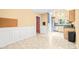 Open dining area adjacent to kitchen with stainless steel appliances and harlequin patterned doorway at 3 Cobble Glen Ct, Durham, NC 27713