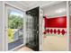 A black front door opens into a room with vibrant red walls and white diamond trim at 3 Cobble Glen Ct, Durham, NC 27713