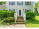 Charming home entrance with steps leading to the front door, surrounded by lush greenery at 3 Cobble Glen Ct, Durham, NC 27713