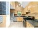 Charming kitchen featuring honey oak cabinets, stainless steel appliances, and a skylight at 3 Cobble Glen Ct, Durham, NC 27713