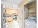 Bright kitchen featuring stainless steel appliances, honey oak cabinets, and access to laundry at 3 Cobble Glen Ct, Durham, NC 27713