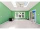 Bright living room with skylights, ceiling fan, and large window providing natural light at 3 Cobble Glen Ct, Durham, NC 27713